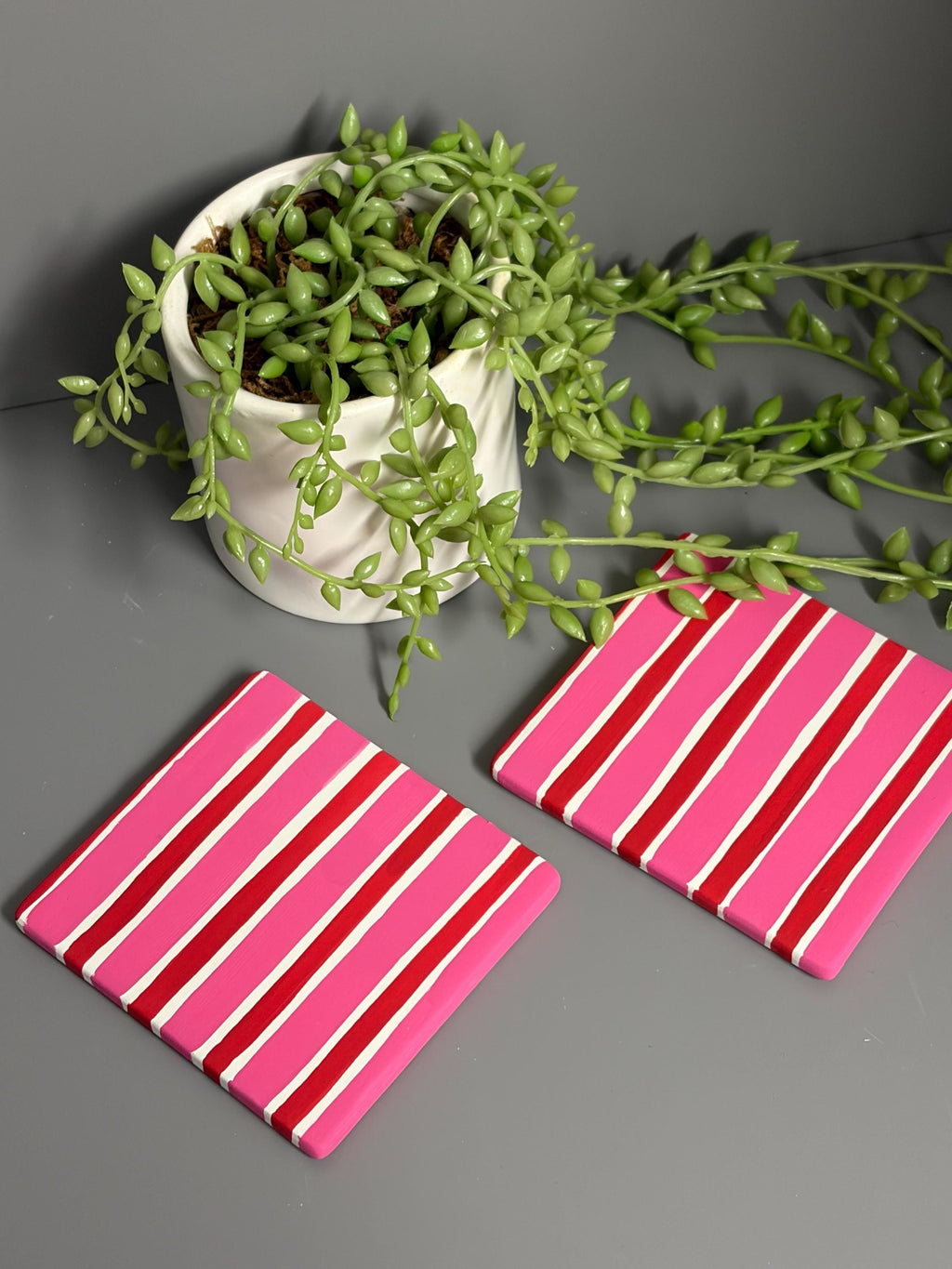 Pink and red stripe hand painted ceramic coasters.