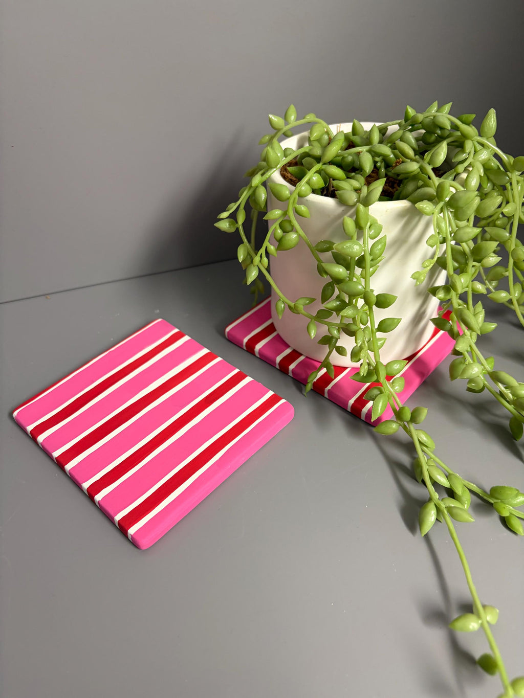 Pink and red stripe hand painted ceramic coasters.